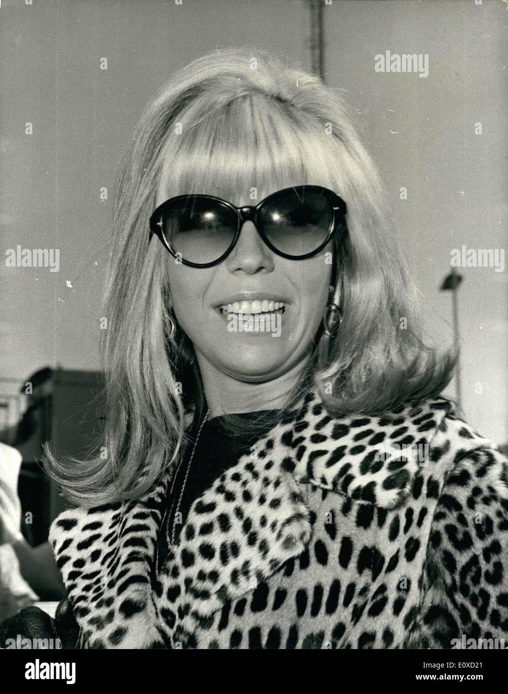 Apr. 21, 1966 - 21-4-66 Nancy Sinatra arrives. Miss Nancy Sinatra arrived at London Airport today for her first visit to Britain. During her stay she will appear on television, record a new album in Pye's Marble Arch Studios, and promote her latest single How Does That Grab You, Darlin'? Nancy first shot to international fame earlier this year when her recording of These Boots are made for Walking topped both the American and the British charts. Keystone Photo Shows: Miss Nancy Sinatra picture on her arrival at London Airport today. Stock Photo