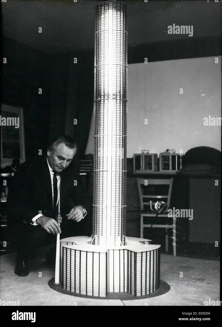 Jun. 06, 1966 - House for 25,000 people - However, Mr. Gabriel is optimistic. He wishes to create a joint-stock company - perhaps in Switzerland - and issue its shares all over the world to obtain the money needed. Our picture shows: Architect Robert gabriel standing at a model of the tower. The attached picture of a drawing shows how the building will look like in reality. There you can compare Mr. Gabriel's construction with some other now existing gigantic buildings. Stock Photo
