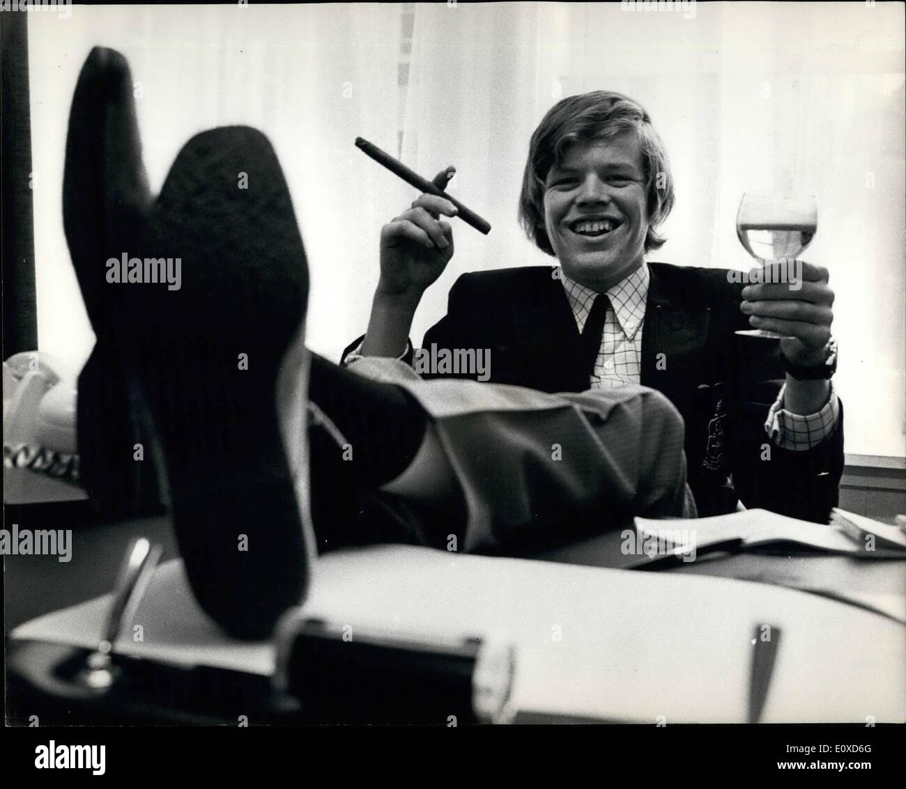 Jun. 06, 1966 - HERMAN AND HIS FOUR HERMITS SIGN MÃ¢â‚¬Å¾Goht FILM CO CT 3 CH BRIMS THEM A COOL Li 6 0.007. Yesterday HERMAN (PETER SHONE) and his four HERMITS signed a film contrast with M.G.M. That will bring them in a cool t1,650,000 ever the next five year.. He and his group regularly oust the BEATLES in America where they will be going on tour next week. PHOTO SHOWN: 18 year old HERMAN (real name PNTNR BOONE) sits back with a celebration drink and a long cigar adding that tycoon touch to the rouagiat aver pap atar to join the millionaire vet. Stock Photo