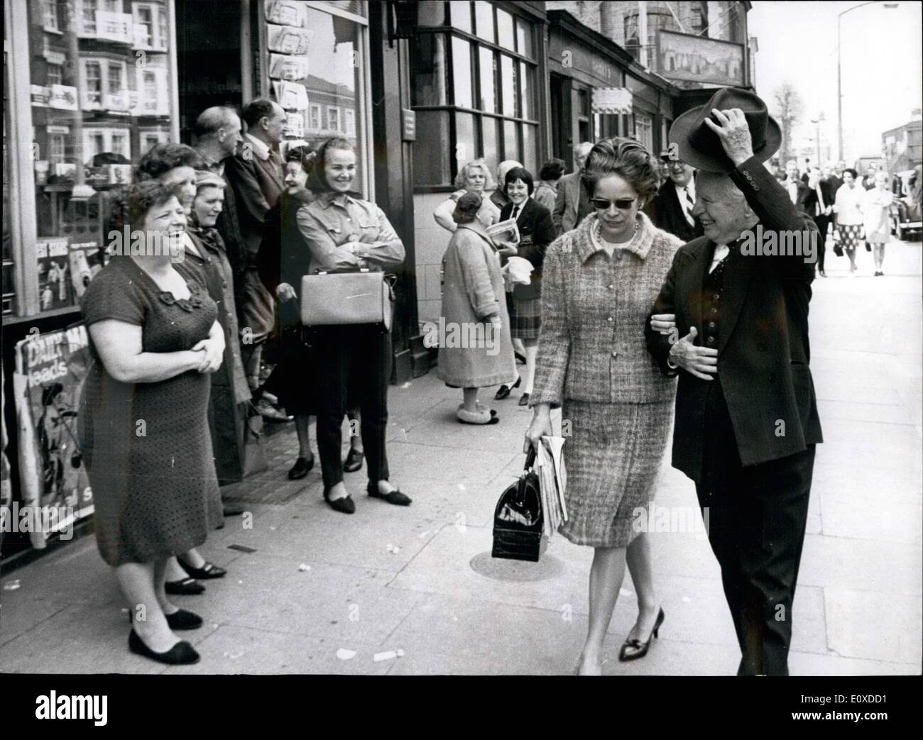May 05, 1966 - Charlie Chaplin in the old Kent Road: Charlie Chaplin finished shooting his new picture ''A Countess from Hong Kong'' yesterday did so only a short way from the place in Southwark, London, where the Chaplin birth place in East Street. Mr. Chaplin did not visit. He has done so already alone. Photo shows Charlie Chaplin, with his wife, Oona, acknowledging his welcome in London's old Kent Road yesterday. Stock Photo