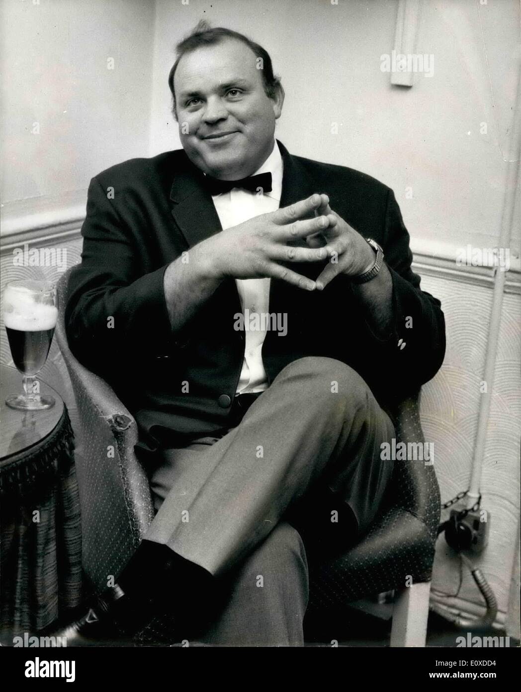 May 05, 1966 - Dan Blocker in London: On Television, actor Dan Blocker - all 20 stone and six feet four-and-a-half-inches of him - is cowboy Hoss Cartwright - in the Bonanza series. But of screen, many surprising things emerge about Mr.Blocker. Like when he sqeezed his massive frame into a chair in the London Palladium's star dressing room yesterday - and talked of poetry, literature and teaching. The fact is, he has an M A degree in English literature. And he said: ''About four years ago I tried to go back to my old job of teaching. ''But it would have been impossible Stock Photo