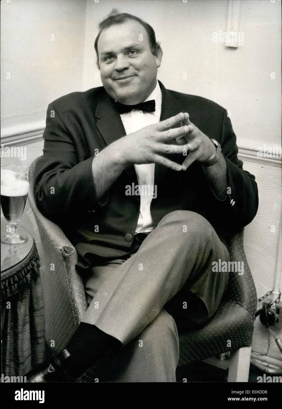 May 05, 1966 - Dan Blocker in London: On television, actor Dan Blocker - all 20 stone and six feet four - and a half inches of him is cowboy Hoss Cartwright - in the Bonanza series. but off screen. Like when he sqeezed his massive frame into a chair in the London Palladium's star dressing room yesterday - and talked of poetry, literature and teaching. The fact is , he has an M.A. degree in English Literature. And he said: about four years ago I tried to go back to my old job of teaching ''but it would have been impossible Stock Photo