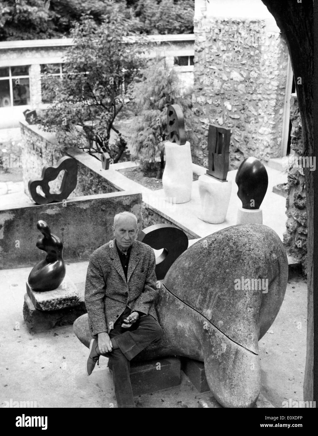 Artist Jean Arp in his garden with some pieces Stock Photo