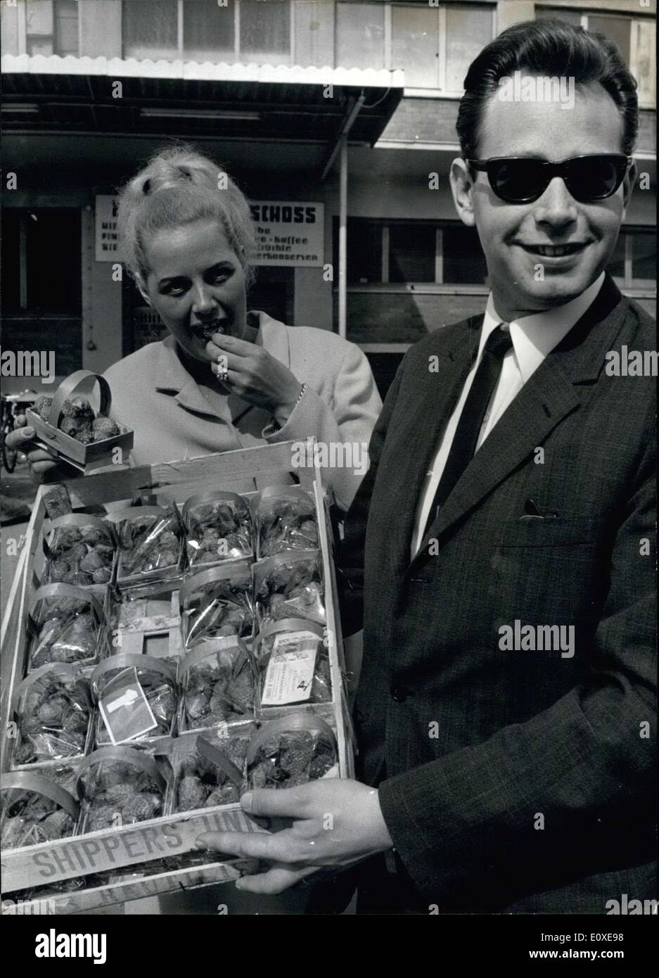 May 09, 1966 - Susanne here couldn't resist the temptation to buy the first strawberries of the season from this Koeln seller. Stock Photo