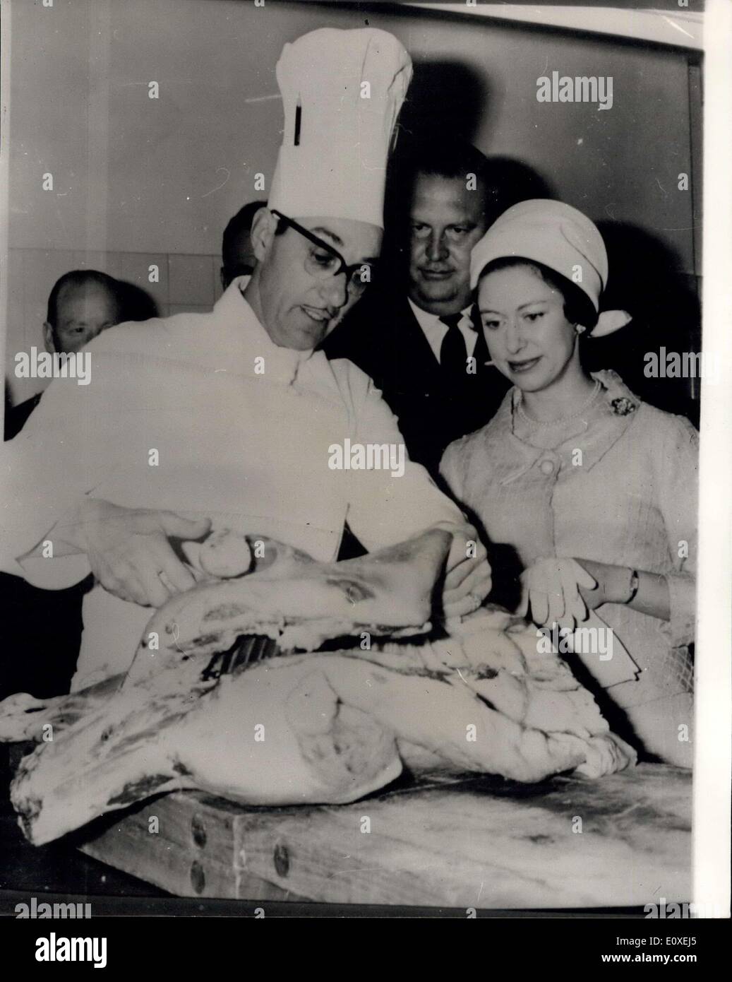May 24, 1966 - Princess Margaret Opens The Rank Organisation's Give Bridges Hotel In Gateshead: Photo Shows Princess Margaret speaking in impeccable French to the head of the Five Bridges Hotel, Mr. A. Requier, of Bordeaux, France, as he explains the art of serving up a lamb's eareas. In the center looking on is Mr. Dowson of Rank Organisation. Mr. Requier was a member of the French Resistance. Stock Photo