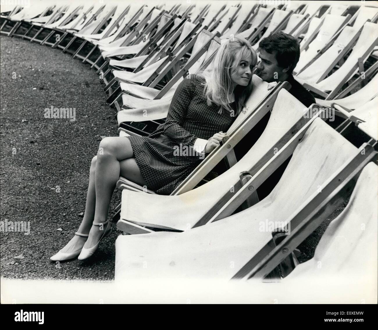 Aug. 08, 1966 - Deckchair Break,: Dudley Moore, the noted musician and funny man - is pictured yesterday with his girl friend, Suzy Kendall, among the deck chairs in Hyde Park, when taking a break from filming a musical together called ''Thirty Is A Dangerous Age, Cynthia' Stock Photo