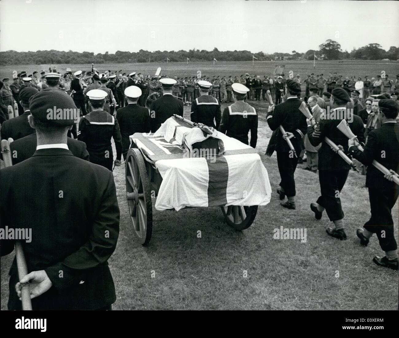 Jul. 07, 1966 - Burial party for the British rifle: The Services, when they think of a joke, exploit it with enthusiasm, and that was what they did yesterday. The navy, assisted by some Army and Air Force people, arranged a mock funeral for the Lee Enfield No. 4 rifle, standard infantry weapon of the last year, which is gradually being replaced by NATO's new F.L. rifle. At the Bisley range in Surrey, where a United Services shooting match was being held, 26 Naval officers and men in No. 1 uniform escorted a gun-carriage with a No. 4 rifle arranged on top of a coffin draped with the Union Jack Stock Photo