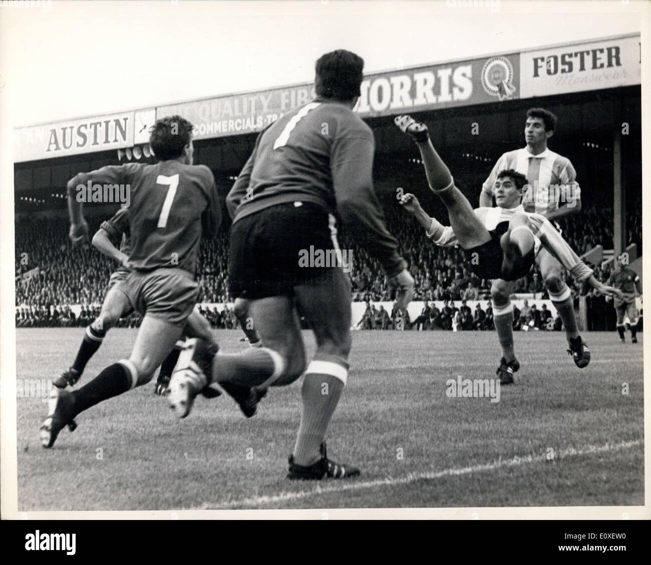 Jul. 14, 1966 - Football. The 1966 World Cup ?Spain v. Argentine at Willa Park, Birmingham. Albrecht, of Argentine, clears off the line with a scissors kick. Ufart (No 7, Spain) rushes in an Argentine goalkeeper Roma (No 1) looks on. Stock Photo