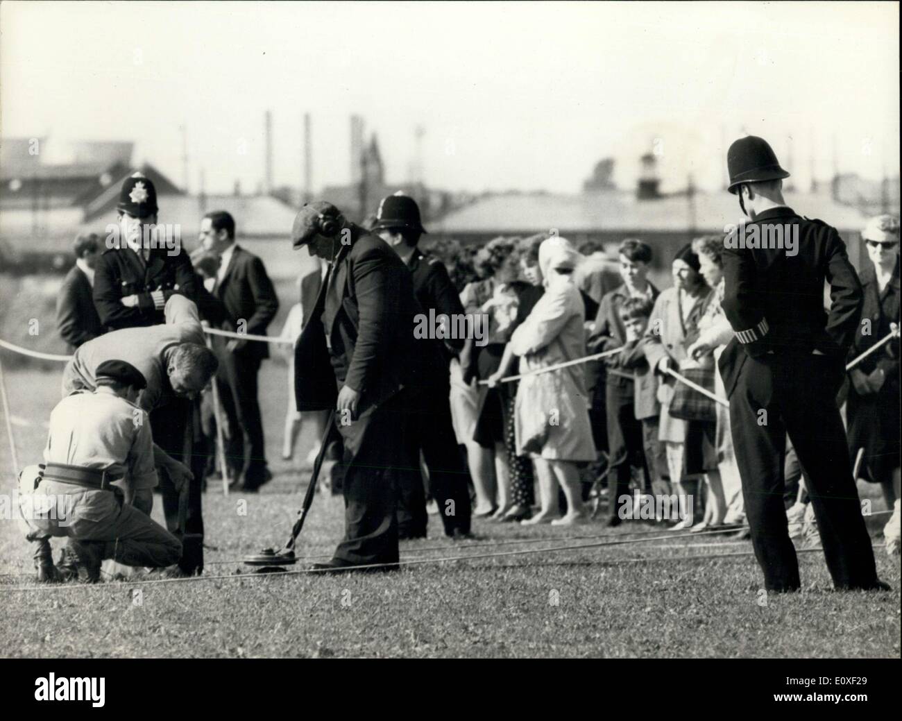 Aug. 13, 1966 - The Army called in to help in the murder hunt for clues ? The army was called in this afternoon to help in the hunt for clues in the shooting of three policemen in Braybrock Street yesterday. Photo Shows: Members of the Bomb Disposal Units watched by police start work with mine detectors on the common Braybrock St. Shepherd?s Bush for clues in the murder of the three policemen who were shot down yesterday. AM/Keystone Stock Photo