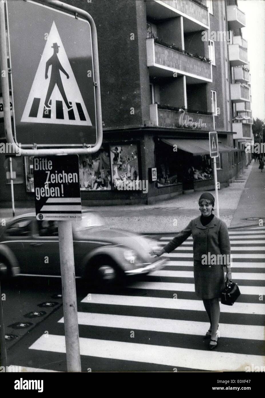 Jul. 23, 1966 - The zebra stripes always warn pedestrians of the dangers of walking on the street. In order to further warn pedestrians during chaotic rush hours, signs have been installed. The signs read ''Bitte Zeichen geben!'' or ''Please signal!'' Whether or not the signs work remained to be seen. Stock Photo
