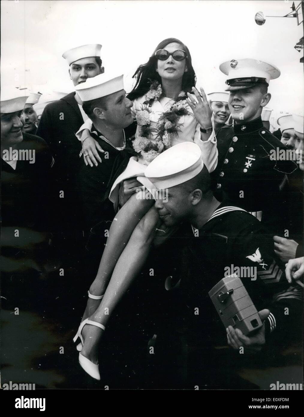 Aug. 08, 1966 - Nancy Kwan is ship's Mascot: Down at south railway jetty in Portsmouth yesterday, yesterday, 2,800 American sailors were on duty entertaining their new 'mascot', actress Nancy Kwan. On board the USS Randolph, there was an Hawaiian band playing at full steam, and grass - skirted girls. And there were garlands of pink and gold chrysanthemums, bought for 30s. each from a local florist, for guests. Miss Kwan managed to sign a, ing-size picture of herself, accept a plaque and an engraved lighter, and thank the crew for making her their mascot Stock Photo