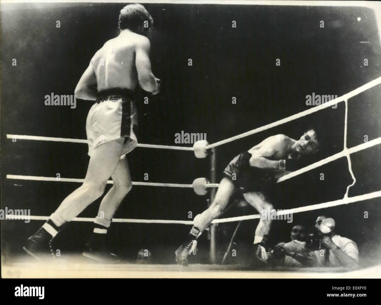 Sep. 09, 1966 - Walter McGowan adds the British and Empire bantam titles to his World Flyweight title.: Walter McGowan, flyweight champion of the world, snatched the British and Empire bantamweight titles from Liverpool's Alan Rudkin by defeating him over 15 rounds at Wembley last night. Photo shows McGowan is snat back to the ropes from an attack at Wembley last night. Stock Photo