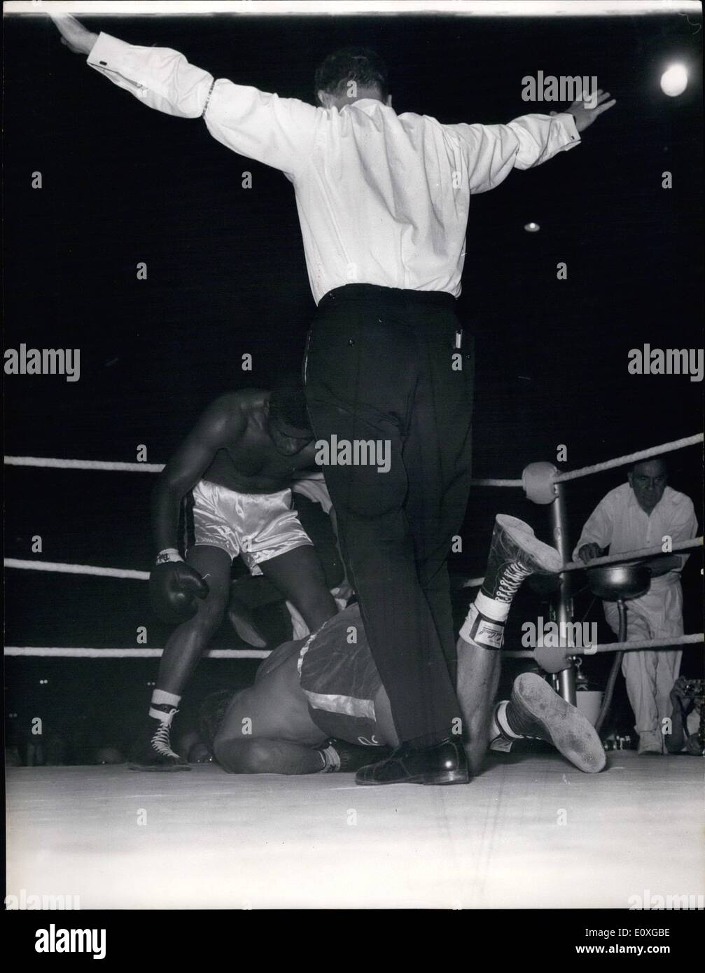 Sep. 09, 1966 - Knock Out: Former World Heavyweight Champion Floyd Patterson of America stand over British and Empire Heavyweight champion Henry cooper as Referee Wally Thom Counts out the fallen British Champion after 2 mins. 20 seconds of the fourth round of their scheduled 10-round contest at Empire Pool, Wembley this evening. Stock Photo