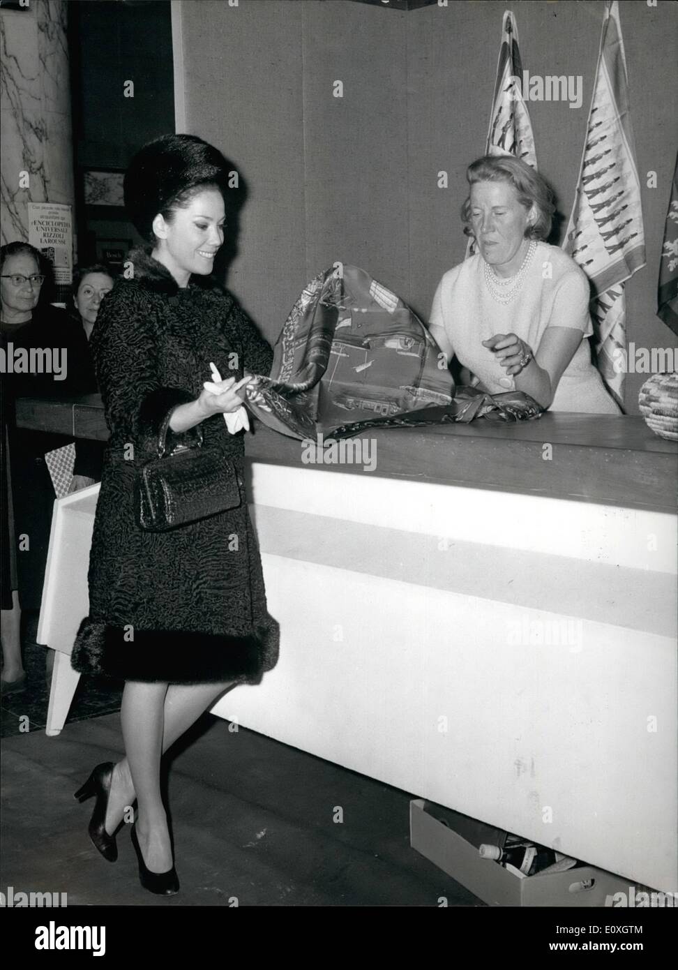 Dec. 12, 1966 - At the exposition ''Christmas Today'' at Eur, Mme. Isabelle Berard, wife of the French Ambassador in Rome, has sold many French foulard to the visitors of the exposition. Photo Shows Mme. Berard selling a foulard to Italian actress Grazia Maria Spina. Stock Photo