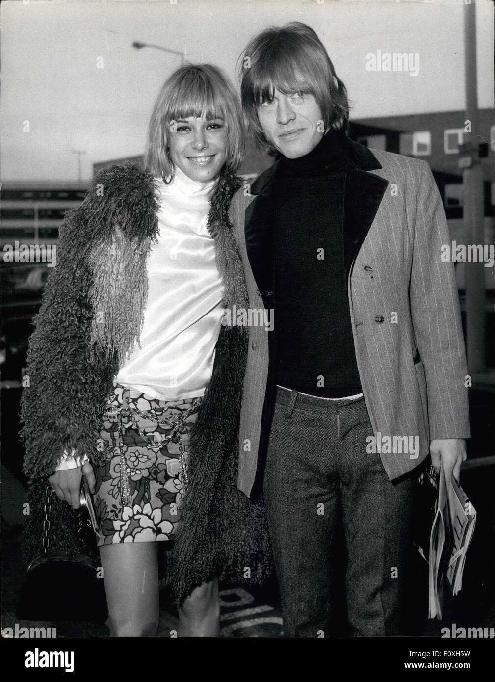 Dec. 12, 1966 - German Actress Arrives by air after Rumours that she is to Marry Brian Jones of Rolling Stones.: Blonde German actress Anita Pallenberg, age 19, flew into London today following romours that she is about to marry the Rolling Stones guitarist, Brian Jones. She was met on arrival at London Airport today by Brian. Photo shows German actress Anita Pallenberg pictured with Brian Jones when she flew into London Airport from Munich today. Stock Photo