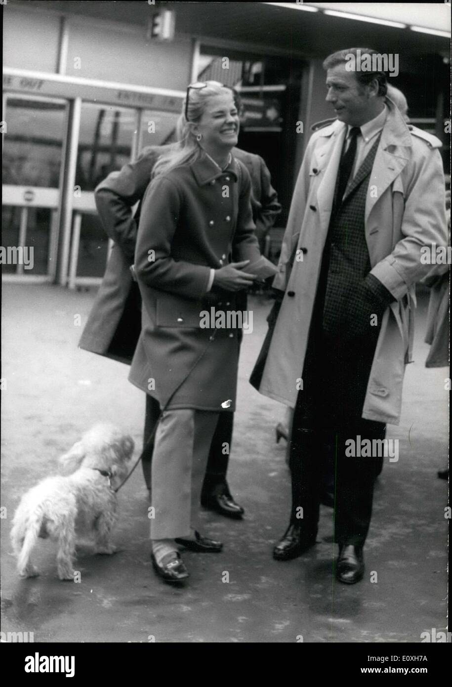 Dec. 23, 1966 - Yves Montand, who was filming the movie ''Live to Live'' in Kenya close to Nairobi under the direction of Claude LeLouch, has arrived in Paris. Picture: Yves Montand photographed upon his arrival at Orly with Candice Bergen, a young actress from across the Atlantic and certain to become a big celebrity. Stock Photo