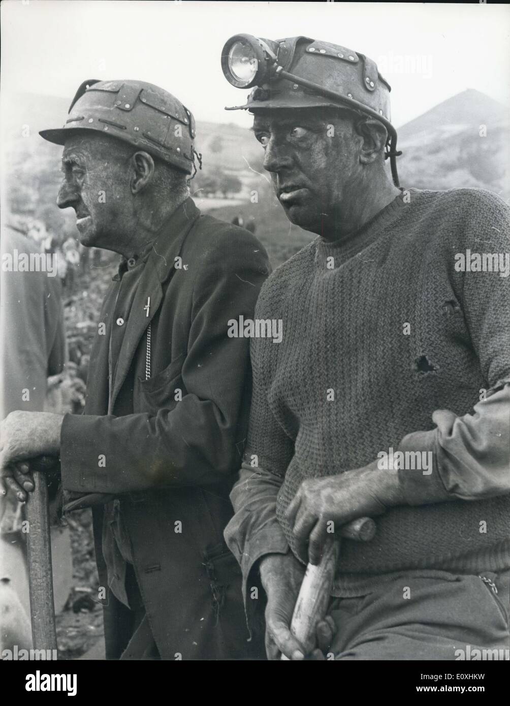 Oct. 22, 1966 - 71 dead and 58 entombed in Avalanche at Aberfan: At least 71 people, mostly children, are dead and between 58 and 60 still entombed at Aberfan, near Marthyr Tydfil, South Wales, after a rain-soaked coal tip avalanched on an infants school, a farm and a row of houses. Eighty five children are safe and 36 are in hospital. Photo shows two of the grim faced rescue workers at the scene of the disaster in Aberfan. Stock Photo