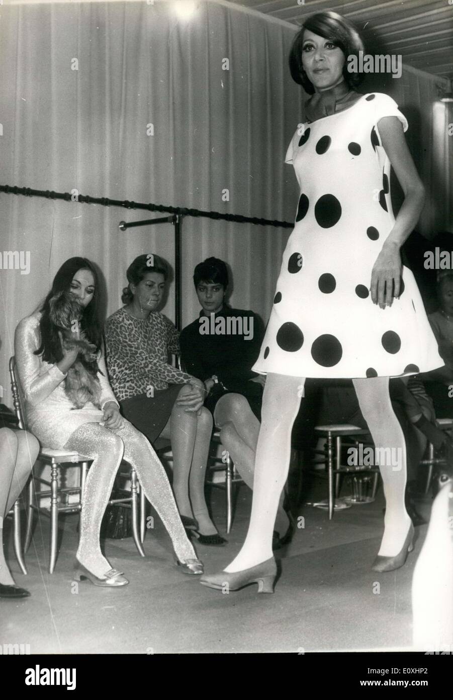 Nov. 04, 1966 - A presentation of the ready-to-wear collection by Georges Hatt. A return to ''Op'Art: diametrical patterns ad big polka dots. The procession: A model wearing an ''Op'' dress. Among the spectators, lots of mini-skits. Stock Photo