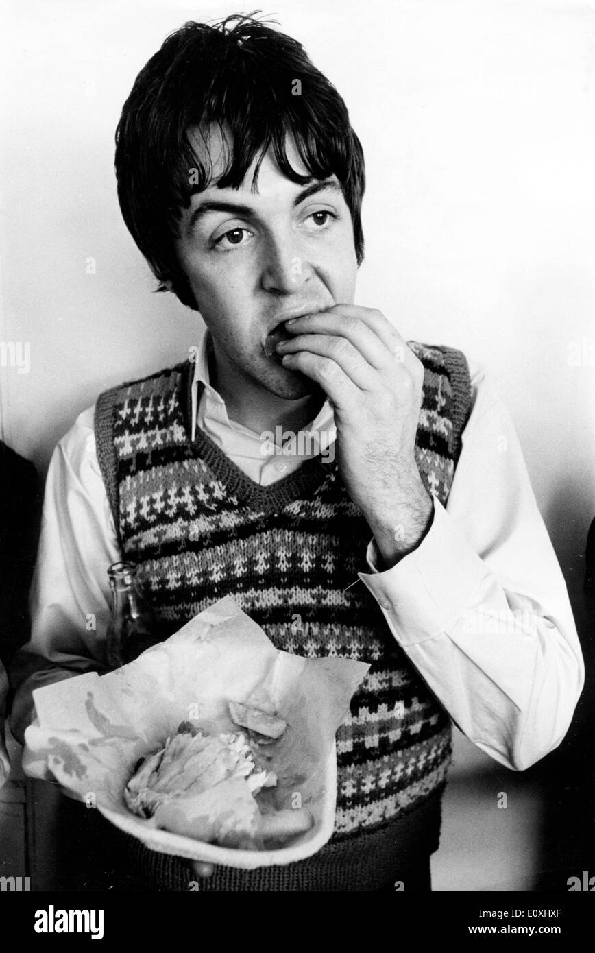 The Beatles' Paul McCartney eating on a break while on tour Stock Photo