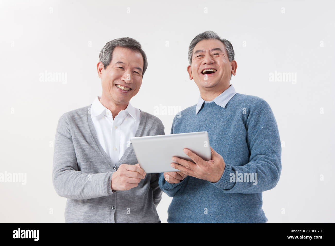 two old men using a tablet Stock Photo