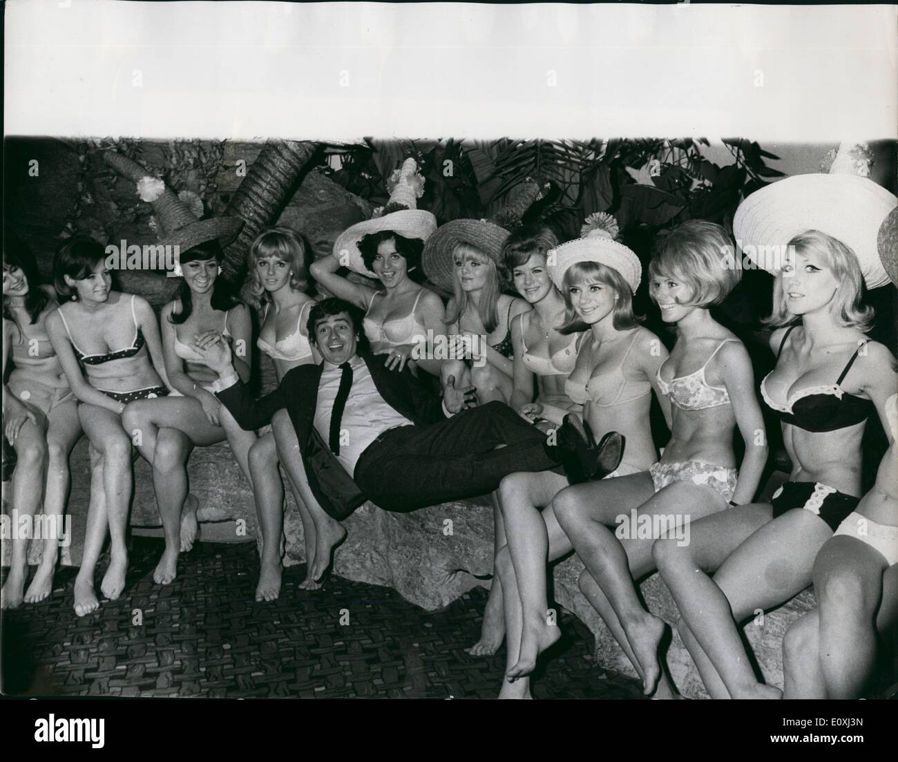 Nov. 11, 1966 - Competitors for the ''Miss Bahamas'' Beauty Contest: 11 beautiful girls from Sweden, Denmark, Germany, Austria and England, met yesterday at the Mayfair Hotel in London, before going off to compete in the Miss Bahamas International Beauty Contest to be held in Nassau on November 26th. Photo Shows Dudley Moores acquainted with the girls at the Mayfair Hotel yesterday. Stock Photo