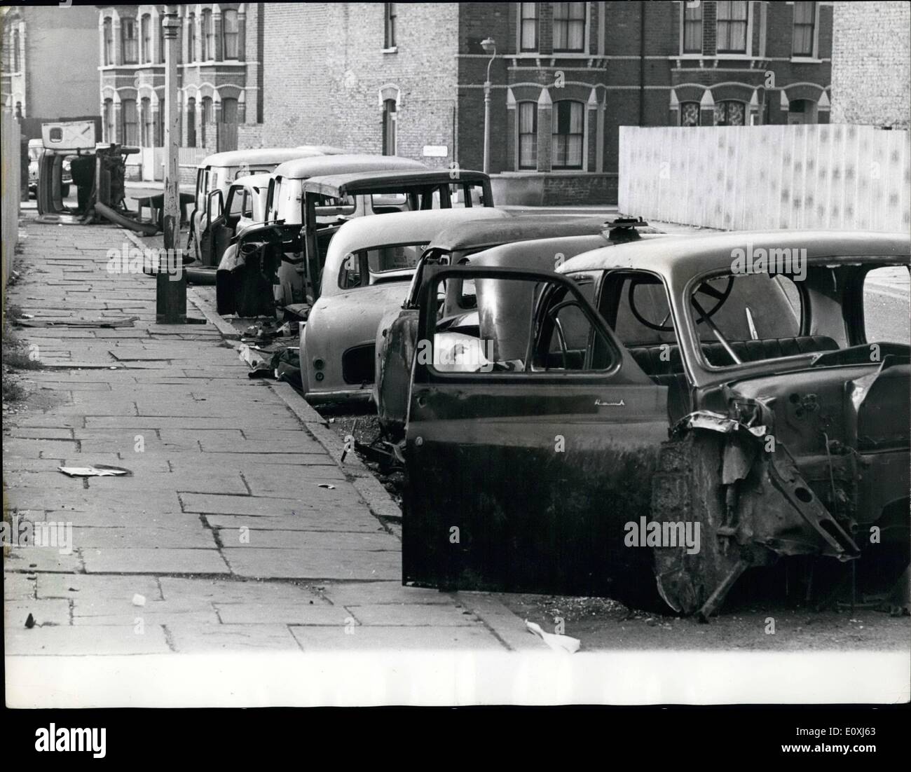 Feb. 02, 1967 - An eyesore in a London Street: Eight cars and vans stand neatly parked on the correct side of the road. Abandoned. Their contents and tyres rifled. Their bodywork burned. They are death and injury traps. They are also a familiar sight to the people of Cowan Street, Camberwell, in South-East London. Stock Photo