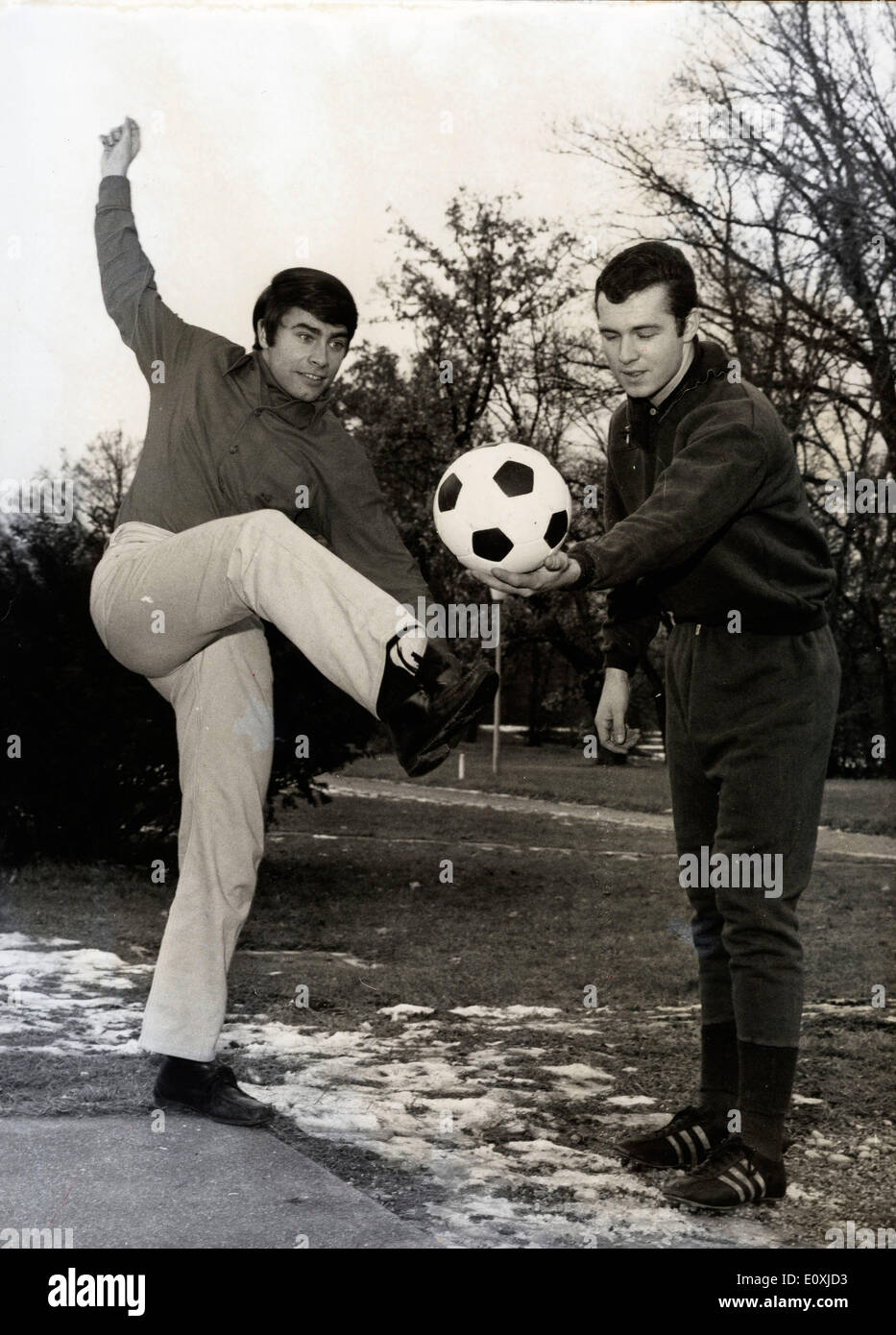 Singer Roy Black and soccer champion Franz Beckenbauer kicking a ball Stock Photo