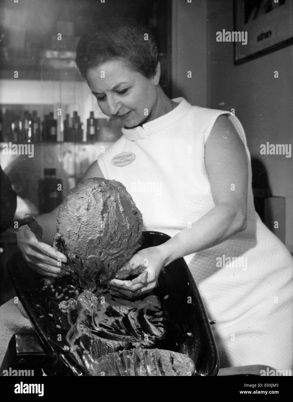 A woman getting a mud bath hair treatment at the salon Stock Photo