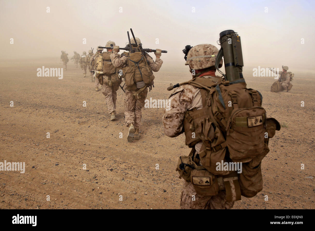 US Marines with Weapons Company, 1st Battalion, 7th Marine Regiment offload in the dust of a CH-53E Super Sea Stallion helicopter during a counter insurgency mission April 28, 2014 in Helmand province, Afghanistan. Stock Photo