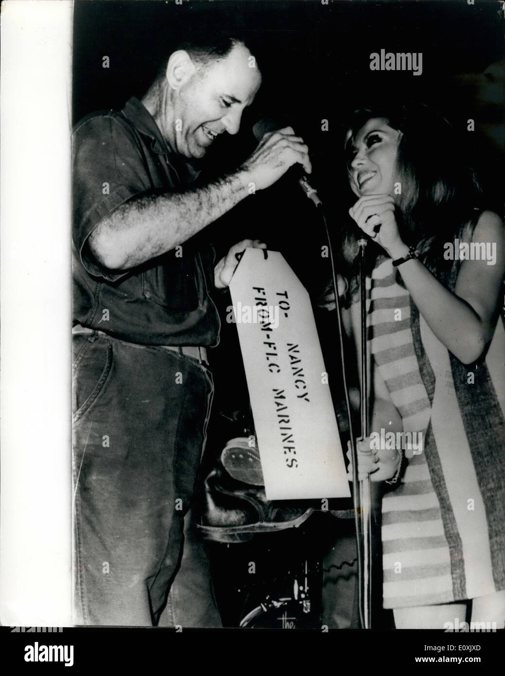 Mar. 02, 1967 - 2.3.67 Nancy Sinatra gets a gift of U.S. Army boots in Vietnam. Photo Shows: Nancy Sinatra is seen being presented with a pair of U.S. Army boots by Brig. General E. Herbold Jr. after singing her hit song These Boots Were Made For Walking to U.S. Troops near Da Nang during her tour to entertain the soldiers in Vietnam. Stock Photo