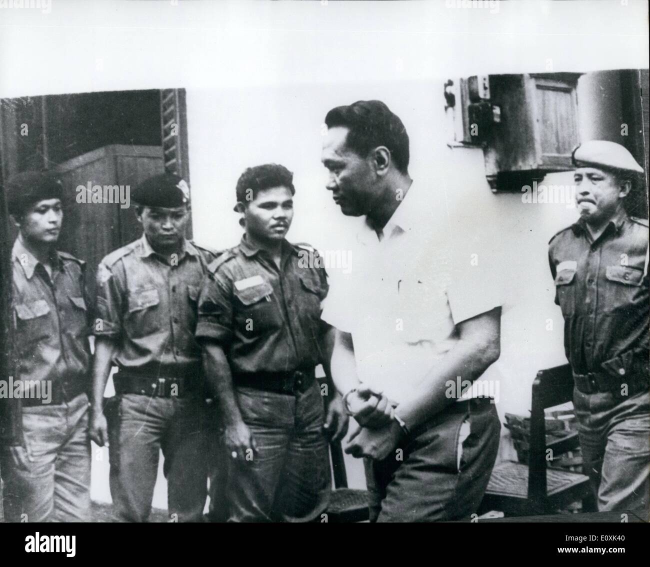 Feb. 02, 1967 - General on trial n Djakarta.: Brigadier - General Supaedjo, 44, is being tried for treason before a military tribunal in Djakarta. The general is said to have been the military brains of the abortive 1965 Indonesian Communist coup aimed to toppling the legal government, and the alleged link between the coup plotters and President Sukarno. Photo shows Brigaier General Supardjo in handcuffs being escorted into the military tribunal building in Djakarta. Stock Photo