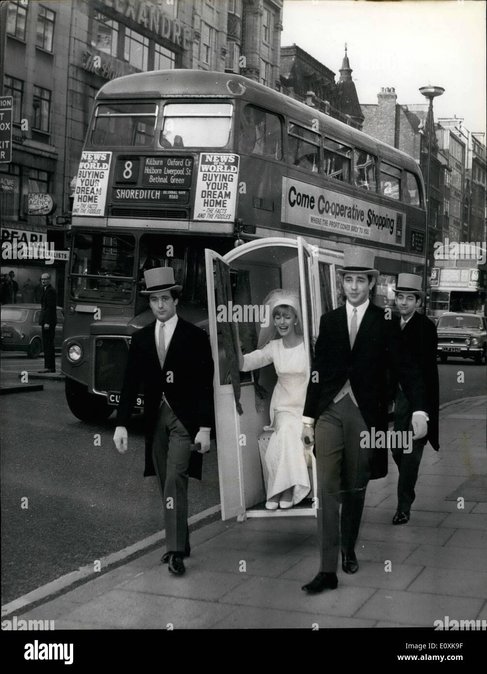 Mar. 03, 1967 - Getting to te church on Time. by Sedan. A bride in a four manned Sedan Chair versus a 210 horse power car, set off for St. Ann's Church in Wardour Street, from Young's Dress Hire, 178, Wardour Street, W.L. this morning. to prove that in congested towns, man power beats motor power at getting the bride to church on time. Especially at Easter, bride hire specialist Louis Young thinks the return of the sedan chair could be a pretty and practical ideas for brides Stock Photo