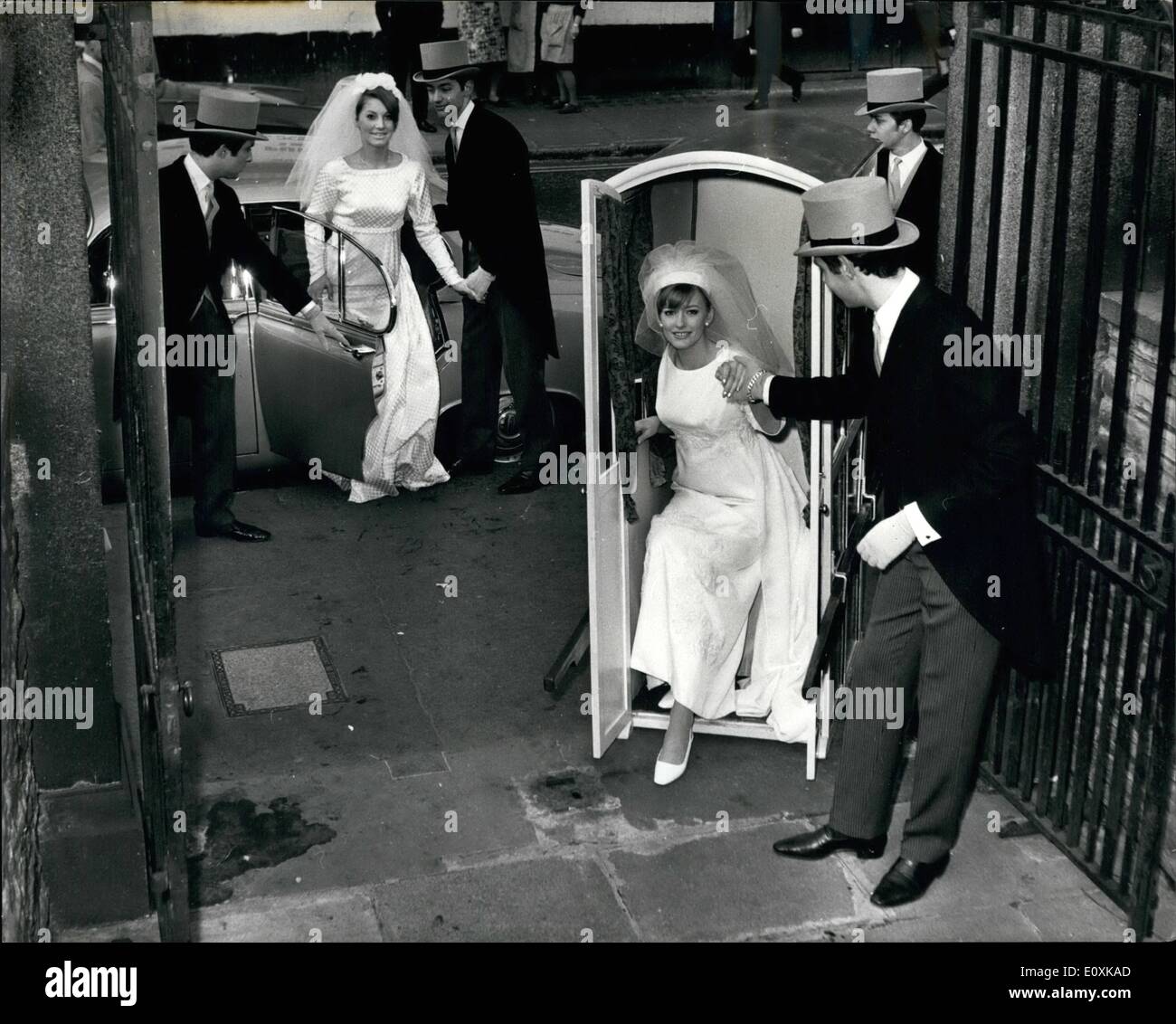 Mar. 03, 1967 - Getting to the Church on time - by Sedan: A bride in a four manned Sedan Chair versus a 210 horse power car, set off for St.Ann's Church in Wardour Street, from Young's Dress Hire, 178, Wardour Street, W.L this morning - to prove that in congested towns, man power beats motor power at getting the bride to church on time. Especially at Easter, Bridal hire specialist Louis Young thinks the return of the sedan chair could be a pretty and practical idea for brides, traffic jams,'' he says, ''it is becoming more and more difficult to get to the church on time Stock Photo