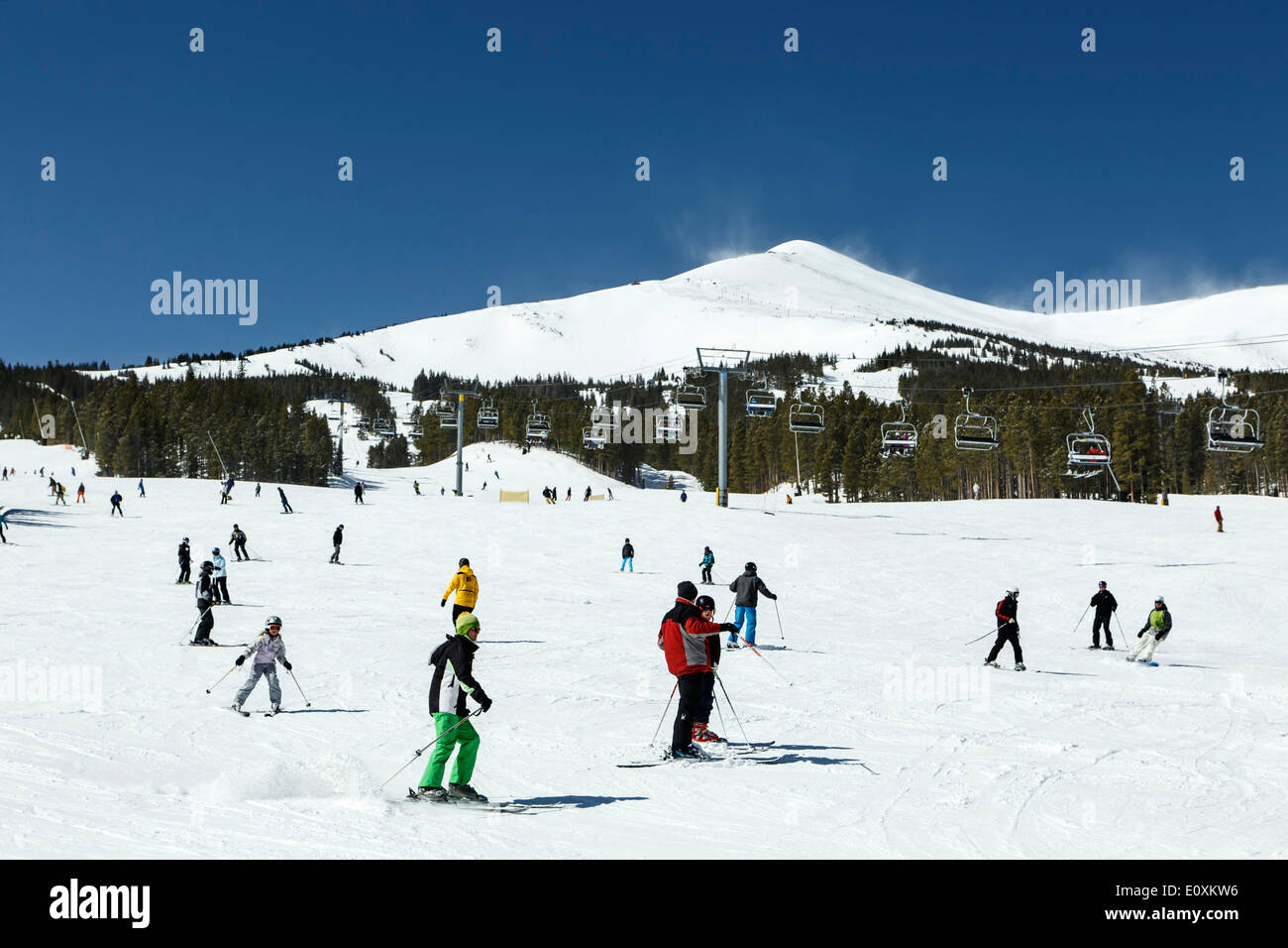 Snow-covered Peak 8, ski lift and skiers/boarders on ski run, Breckenridge, Colorado USA Stock Photo