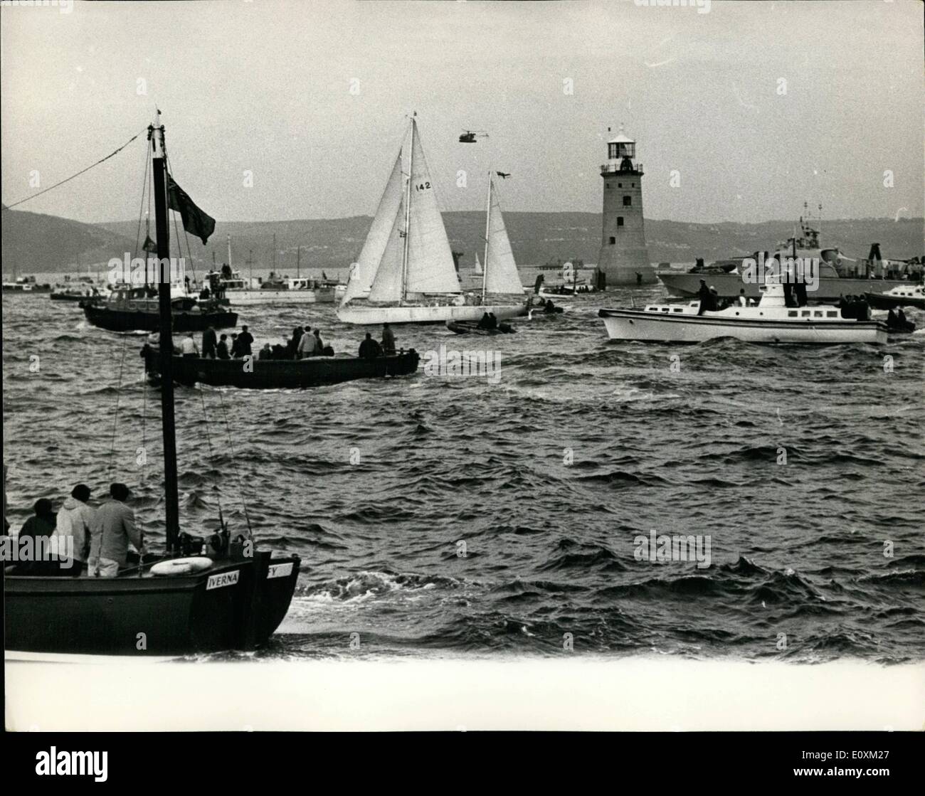 May 05, 1967 - SIR FRANCIS CHICHESTER IS HOME TO A TREMENDOUS WELCOME. Sir Francis Chichester, the lone yachtsman, was given a tremendous welcome, when he arrived back at Plymouth last night, after his epic round the world voyage in Gipsy Moth IV. Keystone Photo Shows:- Sir Francis Chichester in Gipsy Moth lV, pictured crossing the finishing line at Plymouth, marked by the lighthouse - at the end of his 28,500 mile voyage. Stock Photo