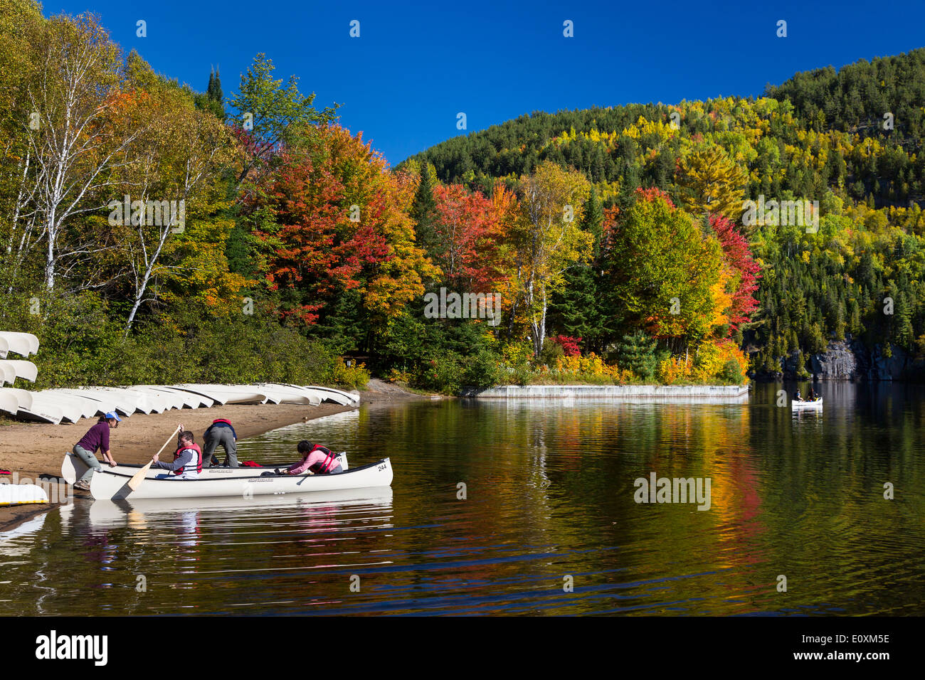 Canoing on a lake with fall foliage color in La Maurice National Park, Quebec, Canada. Stock Photo