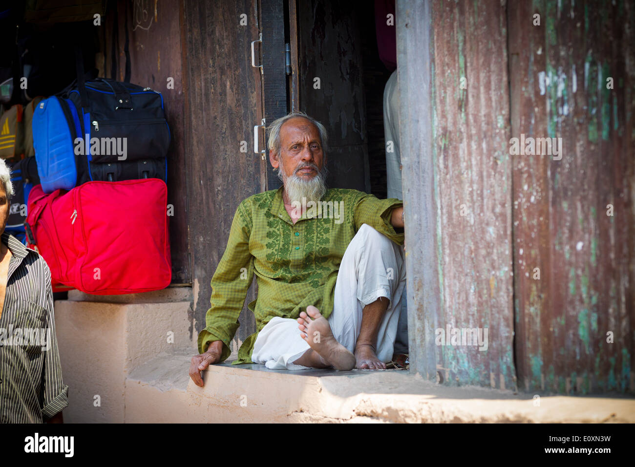 Old Indian gentlemen with a Grey beard sitting by his stall, Mumbai India Stock Photo