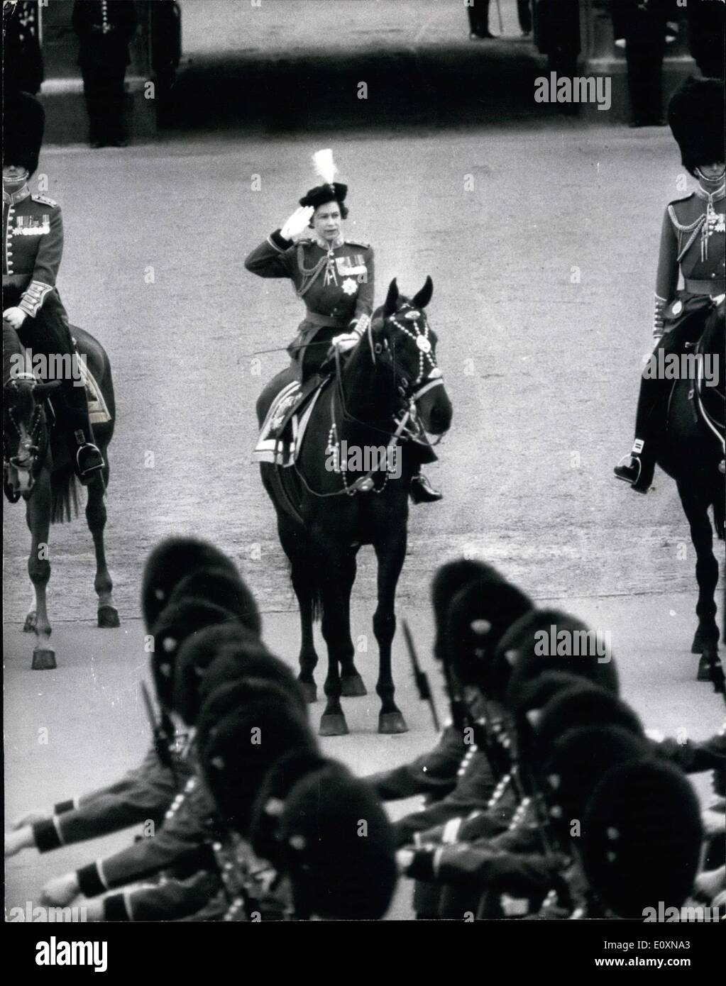 Jun. 06, 1967 - Trooping the colour ceremony: The ceremony of the Trooping of Colour took place this morning on Horse Guards Parade to celebrate the official Birthday of the Queen. The colour that was trooped was that of the 1st Batallion Grenadier Guards. Photo shows H.M. The Queen seen taking the salute from the gates of Buckingham Palace as the 1st Batallion Grenadier Guards march past. Stock Photo