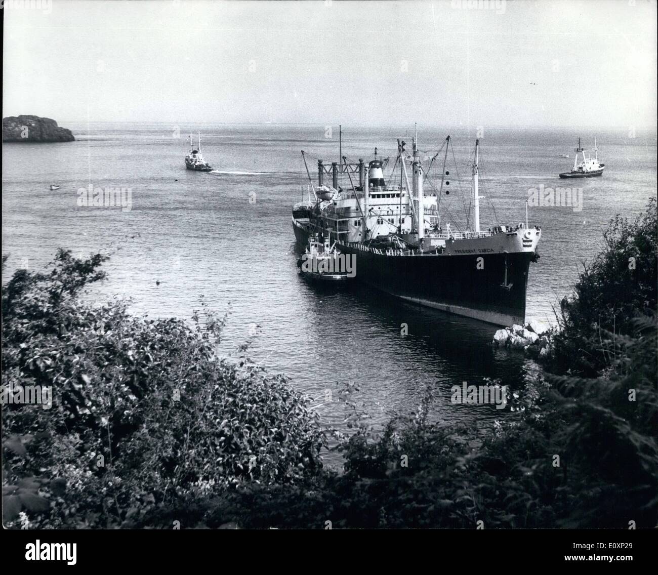 Jul. 07, 1967 - Sanded cargo ship ford in Guernsey. the Philippine cargo ship President Garcia which was aground for a week, was successfully towed off the rocks at Saint's Bay. Guernsey by threes Dutch tugs on Thursday evening. The tugs, two at sea and the other alongside, took an hour to slowly shift the ship. Secres of holidaymakers watched the operation and cheered the crew as the ship was pulled off. photo shows The scene as the president Garcia was successfully towed off the rocks at saints bay, Guernsey. Stock Photo