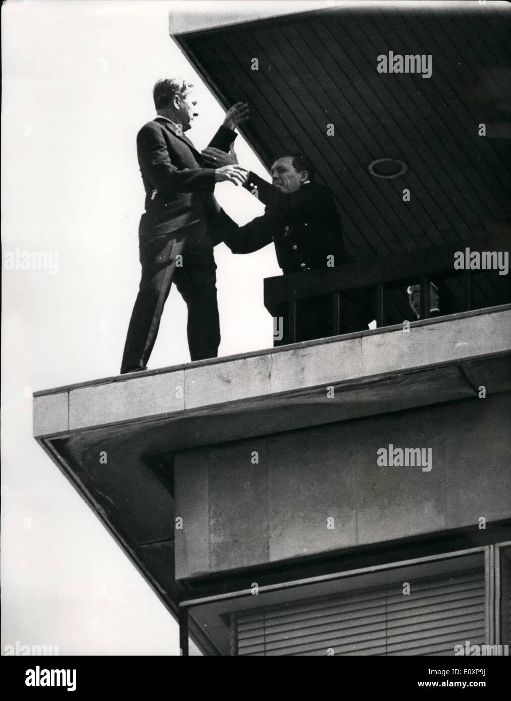Jul. 07, 1967 - DRAMA AT NEW ZEALAND HOUSE: A man stood for over an hour today on the narrow ledge of the viewing balcony of New Zealand House, high above London. He was finally talked to and pulled in by a police officer. Photo shows The man is pulled to safety by a security officer-and was later taken to hospital. Stock Photo
