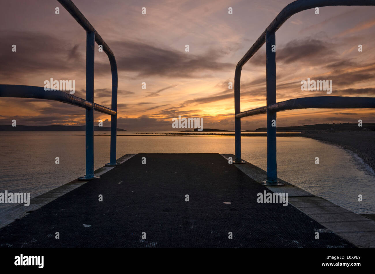 "Dive In"  The view from the top of a diving platform overlooking Galway Bay at sunset Stock Photo