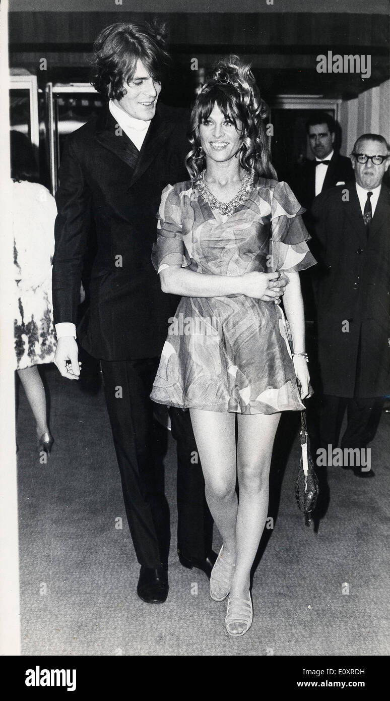 Oct 17, 1967 - London, England, United Kingdom - Actress JULIE CHRISTIE wearing a multi-colored mini dress, is pictured here, escorted by Don Bessant, as she arrived at the new Odeon, Marble Arch, to attend the world premiere of her latest film 'Far From the Madding Crowd', in which she stars with Terence Stamp. Stock Photo