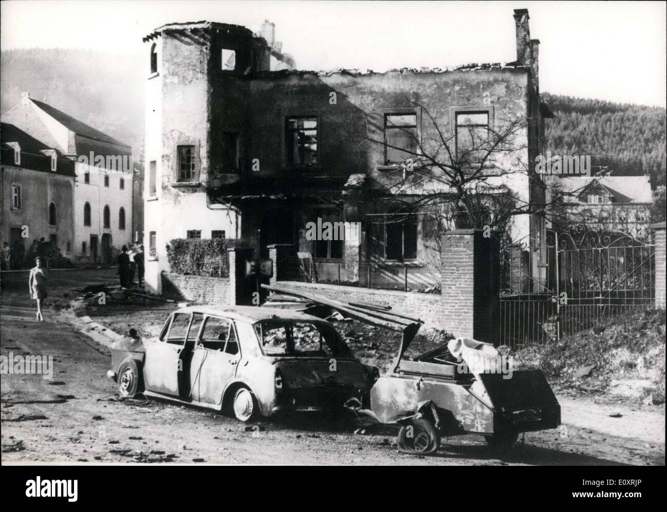 Aug. 22, 1967 - In Belgium, an explosion of a truck carrying 40,000 liters of liquid gas caused the deaths of 9 people. 34 people were injured, 5 of whom are in serious condition. About 15 homes were seriously damaged and cars went up in flames. Dutch people were inside the car pictured and burned to death. Stock Photo