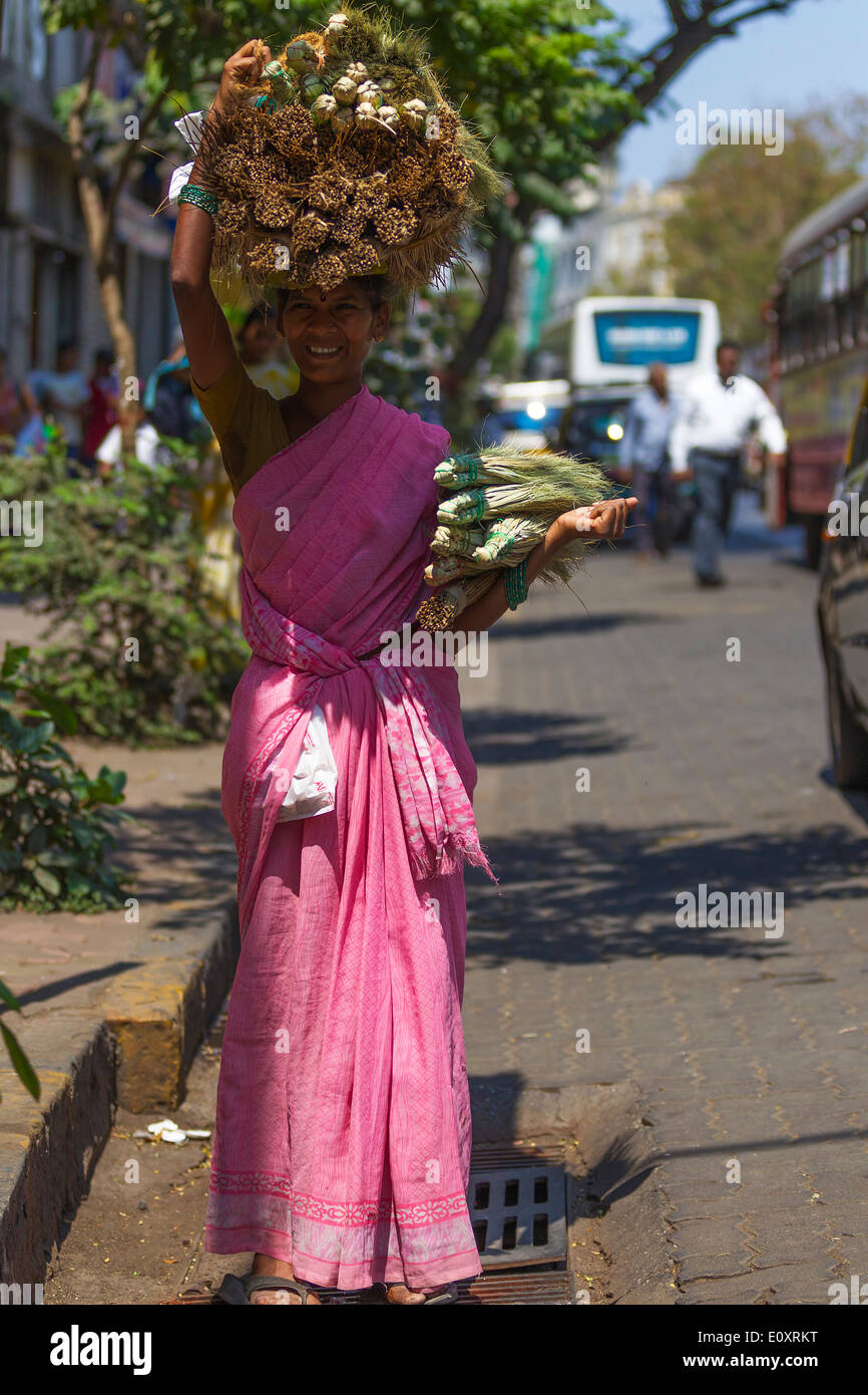 Female carrying a heavy load on her head, Mumbai India. Stock Photo
