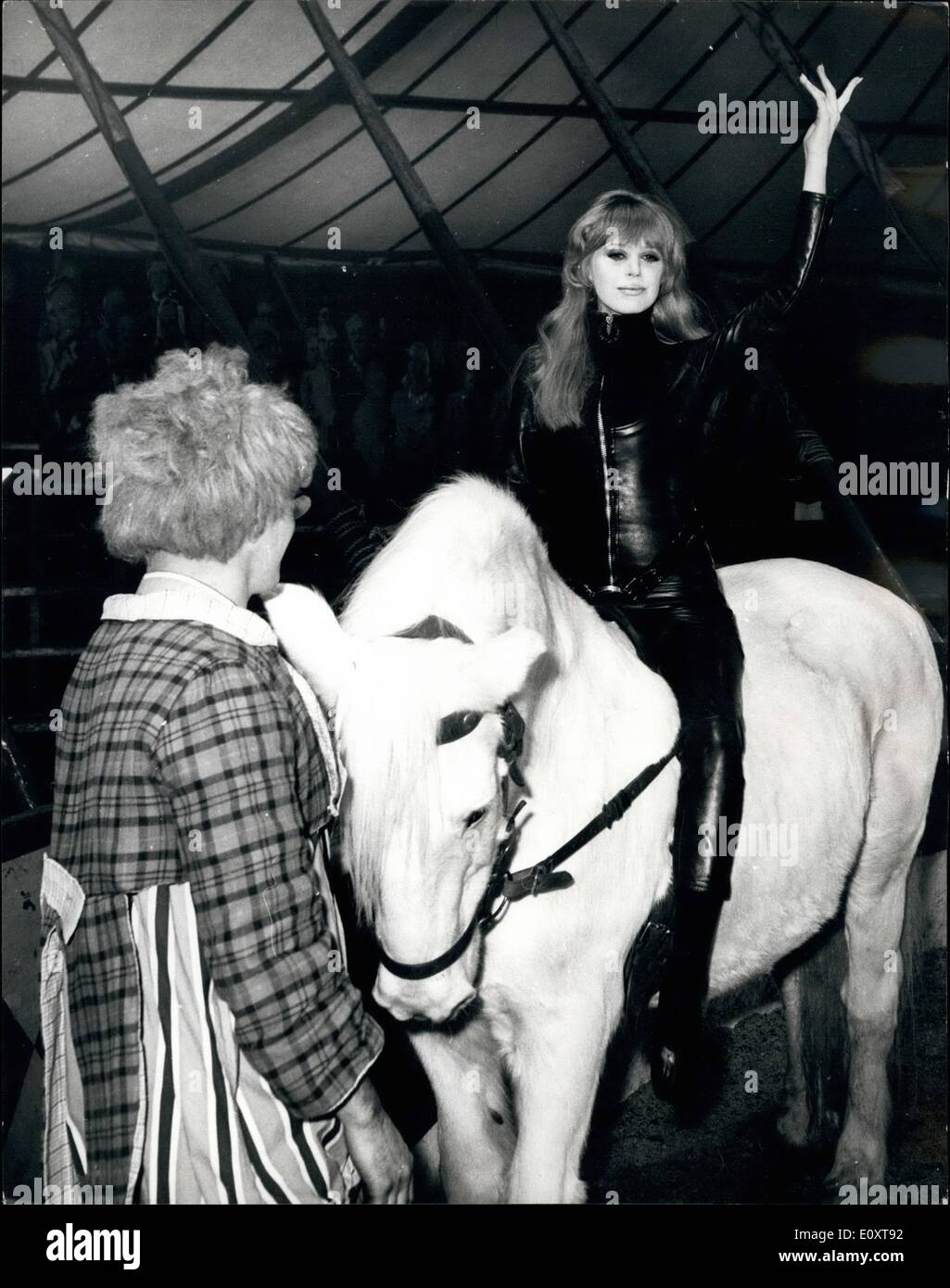 Nov. 11, 1967 - Marianne Faithfull and Alain Delon At The Circus - For New Film: Marianne Faithfull and Alain Delon, stars of the Anglo-French Production Girl On A Motorcycle, spend a day at the circus for dream scenes in this lyrical love drama, directed by Jack Cardiff, and co-produced by William Sesscon and Sacha Kamenka, for distribution by British Lion. Wearing her black leather motor cycling suit designed especially for her by Lanvin - Marianne circles round the sawdust ring on a circus horse while Alain - who plays her lover Daniel in the film - cracks a commanding whip as Ringmaster Stock Photo