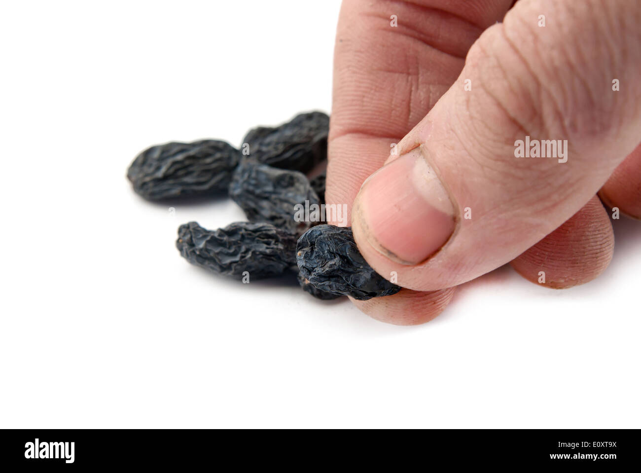 raisins in hand on white background Stock Photo - Alamy