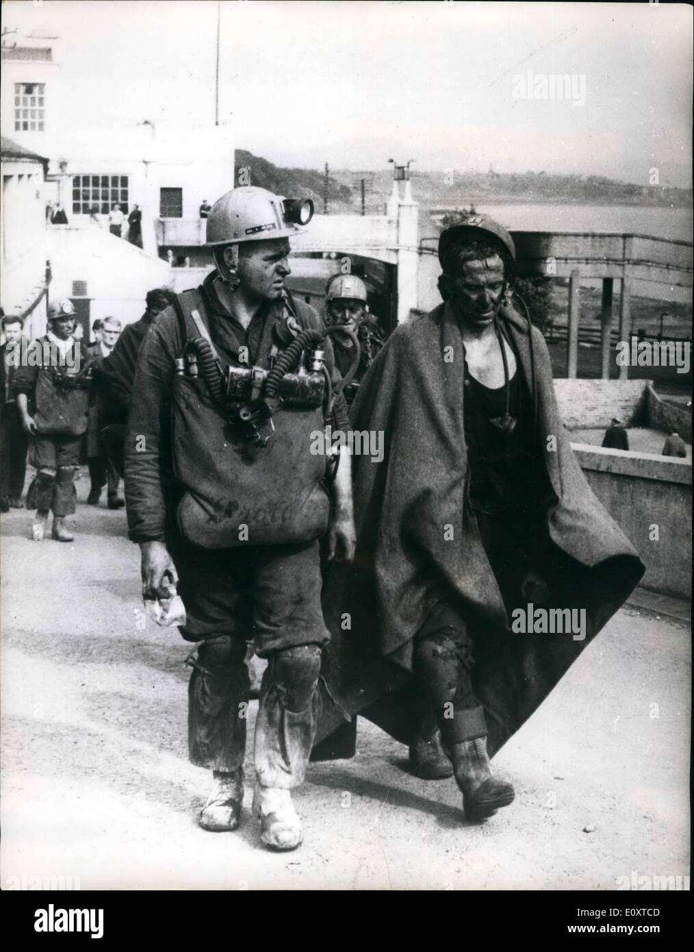 Sep. 09, 1967 - Six die in blazing colliery disaster in Scotland. two miners were rescued yesterday after being trapped underground for nearly 12 hours by a fire in Michael colliery, one of Scotland's biggest mine in east nemyss, fife, six men are known to have died and three others are still missing, nearly 300 men escaped from the fire. photo hows A mine rescue worker who was overcome by the smoke is led away from the colliery entrance. Stock Photo