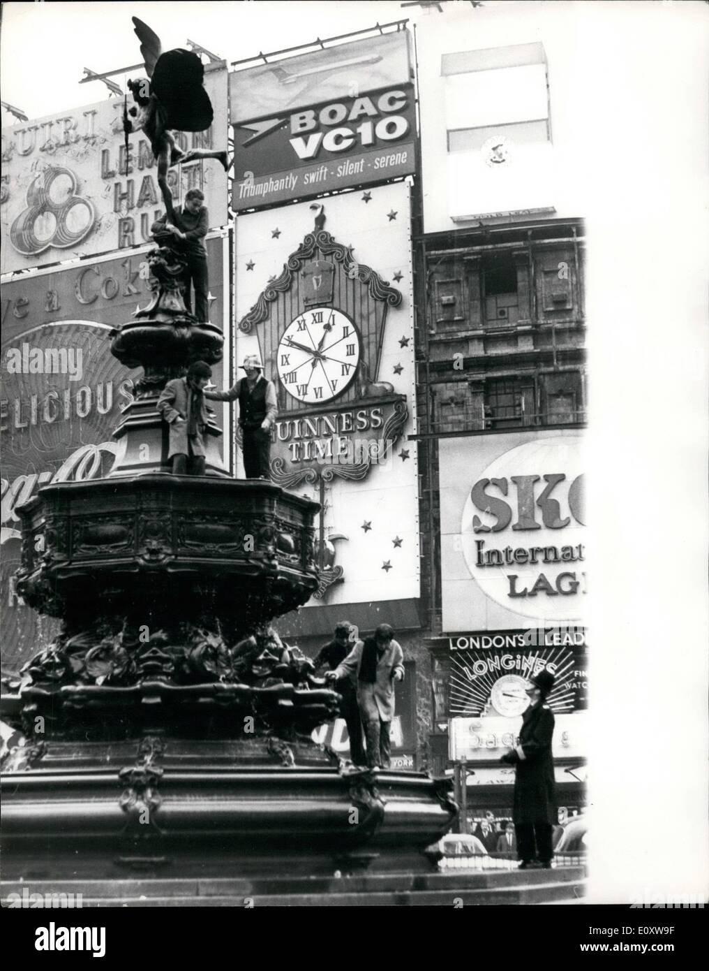 Nov. 23, 1967 - 23-11-67 Beatniks climb Eros. Keystone Photo Shows: Watched by a policeman, a group of beatniks are seen on the Eros statue in Piccadilly Circus, on which they climbed today. Stock Photo