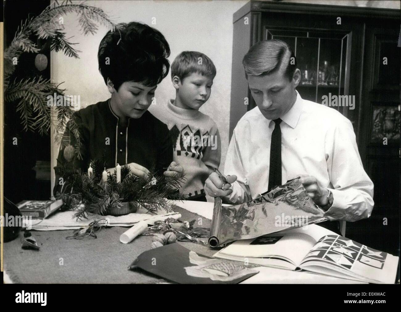 Nov. 29, 1967 - Friedel Lutz is pictured here with his family, wife Helga and son Peter, doing Christmas decorations. Lutz played for ''Eintracht Frankfurt'' and guested for ''Munich 1860.'' He will play his 400th game for Frankfurt against this very team. Stock Photo