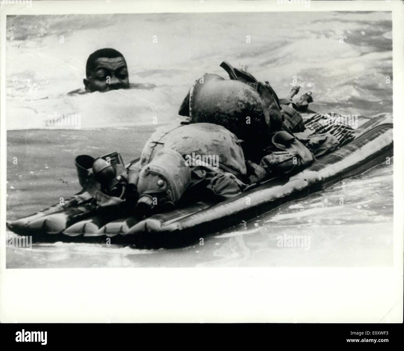 Oct. 10, 1967 - War in Vietnam.: One Way to Cross a Flooded Stream.: Pushing his combat gear-loaded air mattress, an infantryman swims across a monsoon-flooded stream during mission with the 1st. Battalion 5th. Infantry. The battalion is anticipating in the U.S. 25th, Division's Operation Kolekola, in Hau Nghia Provinces, Vietnam Stock Photo